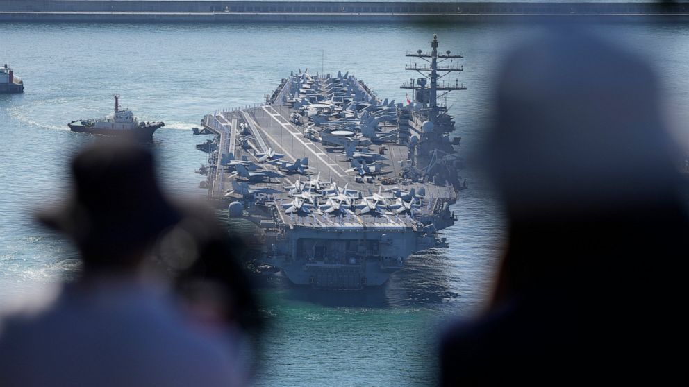 USS Ronald Reagan is escorted as it arrives in Busan, South Korea on Sept. 23, 2022. North Korea warned Saturday, Oct. 8, the U.S. redeployment of an aircraft carrier near the Korean Peninsula is causing a “considerably huge negative splash” in regio